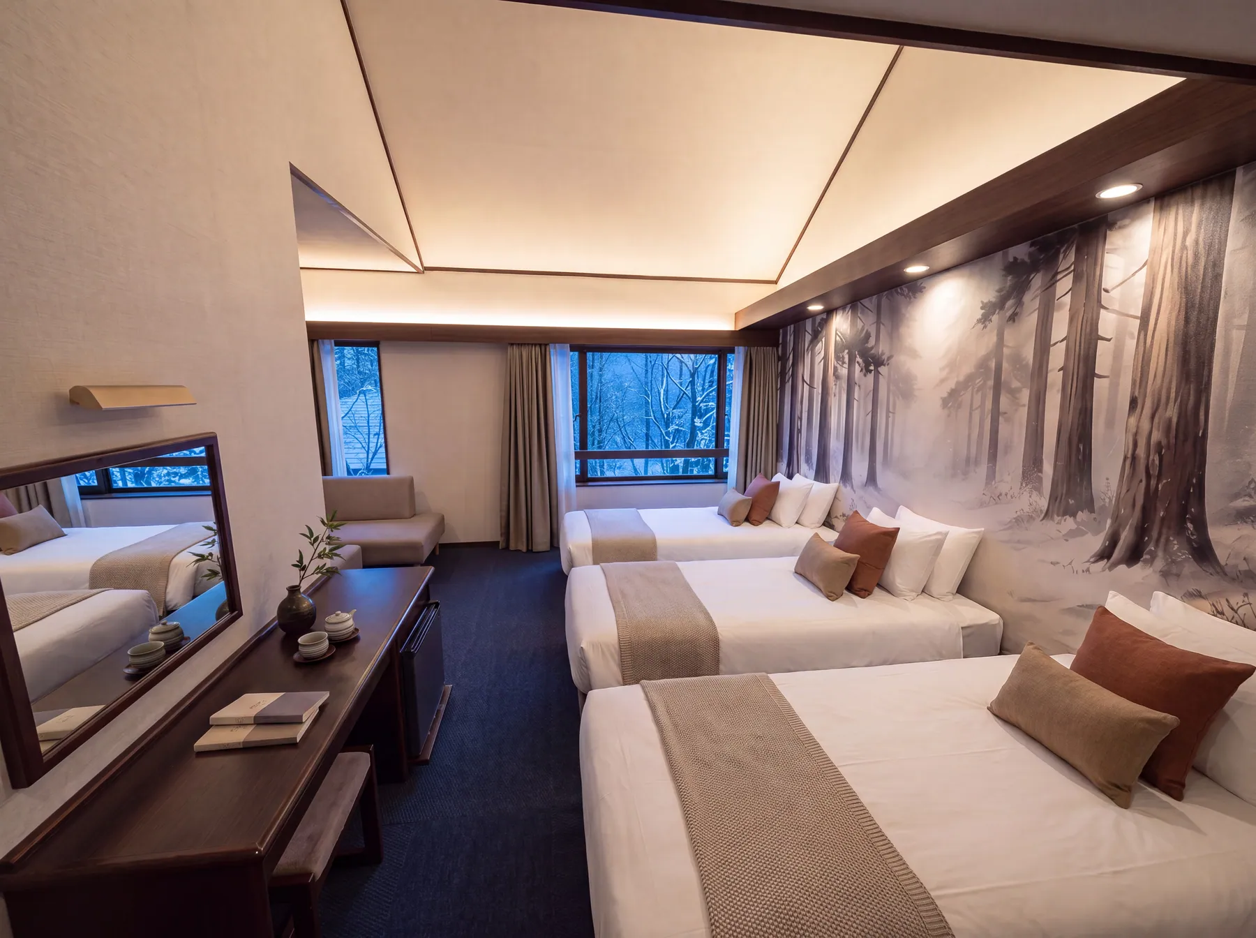 A guest room with a full-wall ink painting of a snow-covered cedar forest behind three beds